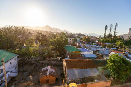 an aerial view of a town with houses and mountains at Studio Standard - AMI APPARTHOTEL in Tôlagnaro