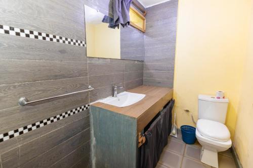 a bathroom with a sink and a toilet at Studio Standard - AMI APPARTHOTEL in Tôlagnaro