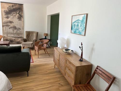 a living room with a couch and a table at Galaxie in Arcachon