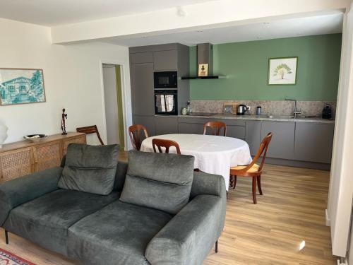 a living room with a couch and a table at Galaxie in Arcachon