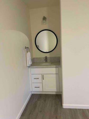 a bathroom with a sink and a mirror at Kope Hale Coffee Farm Private Studio near Volcano Park in Pahoa