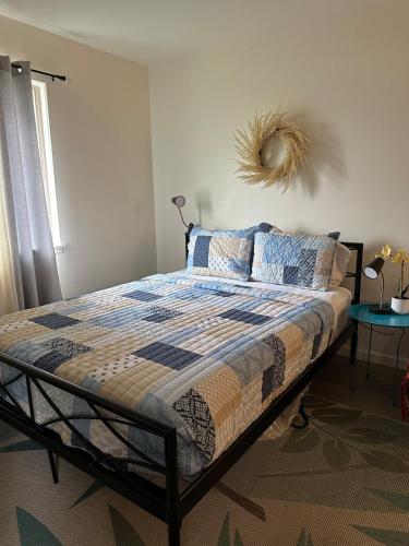 a bedroom with a bed with a quilt on it at Kope Hale Coffee Farm Private Studio near Volcano Park in Pahoa