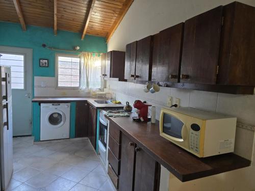 a kitchen with a microwave on top of a counter at House in Plottier in Plottier