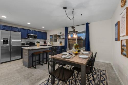 a kitchen with a table with chairs and a refrigerator at Splash In Your Private Free Heated Pool! in Glendale