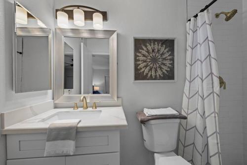 a white bathroom with a sink and a shower at Splash In Your Private Free Heated Pool! in Glendale