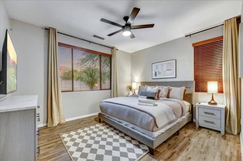 a bedroom with a bed and a ceiling fan at Living The Dream! Gated Wfree Private Heated Pool in Anthem