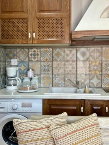 a kitchen with a sink and a dishwasher at Villa Kaldera Skiathos in Skiathos