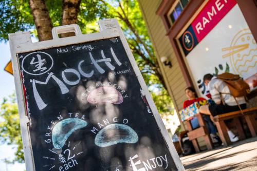 a sign in front of a restaurant with a mushroom on it at Stay Portland - Super Studio in Brooklyn in Portland