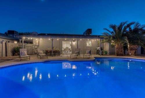 a swimming pool in front of a house at night at Premium Home With Free Private Heated Pool! in Tempe