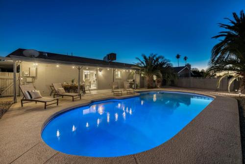 a large blue swimming pool in a yard at Premium Home With Free Private Heated Pool! in Tempe