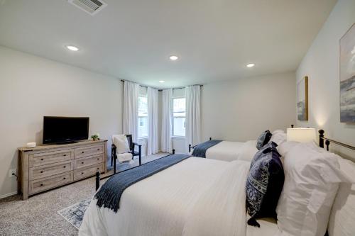 a bedroom with two beds and a flat screen tv at 4BR Spacious Family Retreat, 5min Lake Conroe, Large Backyard Grill in Montgomery