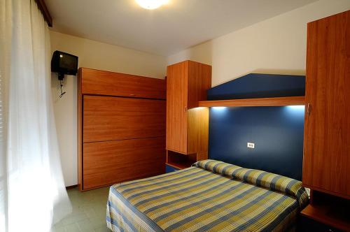 a bedroom with a bed and a bunk bed at Hotel La Fenice in Lido di Jesolo