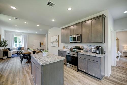 a kitchen and living room of a home at 4BR Spacious Family Retreat, 5min Lake Conroe, Large Backyard Grill in Montgomery