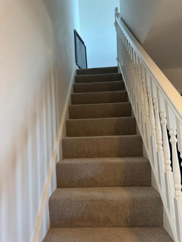 a flight of stairs with a blue sky in the background at Sapphire Shores- Spacious 2-Bedroom Apartment with Balcony & Sea View in Portstewart