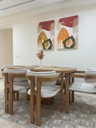 a dining room with a wooden table and chairs at Elegant and comfortable apartment in Tangier, Luxury 3BR, AC, Bright Stay in Tangier