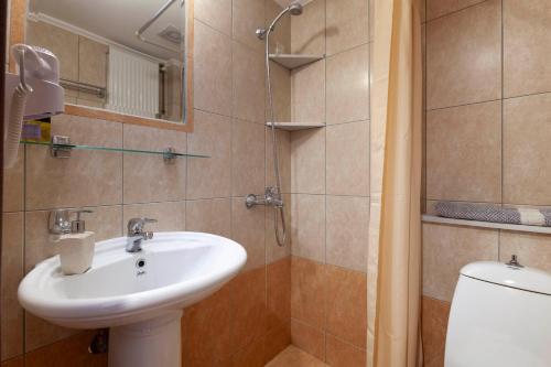 a bathroom with a sink and a toilet at Mpalkoni Sti Monemvasia in Monemvasia
