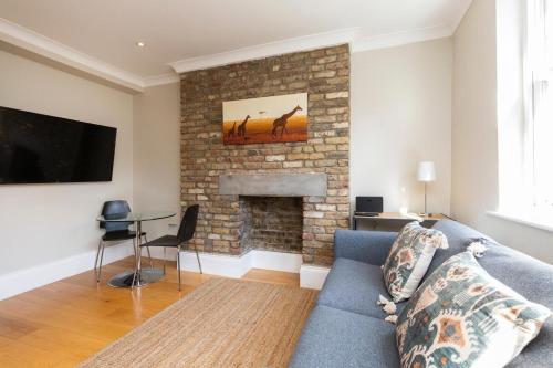 a living room with a couch and a fireplace at Stylish Soho Apartment R2 in London