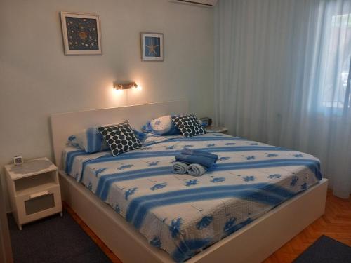 a bedroom with a bed with a blue comforter at House Boris in Slatine