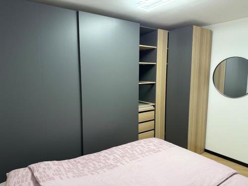 a bedroom with a bed and a closet at Moderno stanovanje - Ptuj in Ptuj