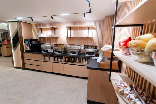 a kitchen with a counter with food on it at Hotel Dorna in Vatra Dornei