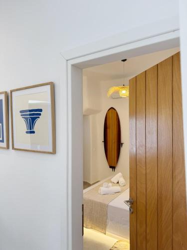 a door leading into a bedroom with a bed at Kukulú Luxurious Cottage with Mini Private Pool in Ano Mera