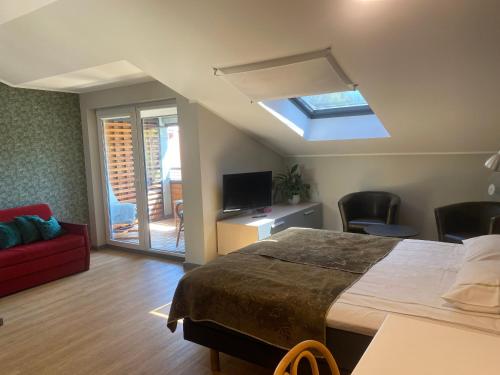 a bedroom with a large bed and a skylight at KURESSAARE TALLINN STREET APARTMENTs in Kuressaare