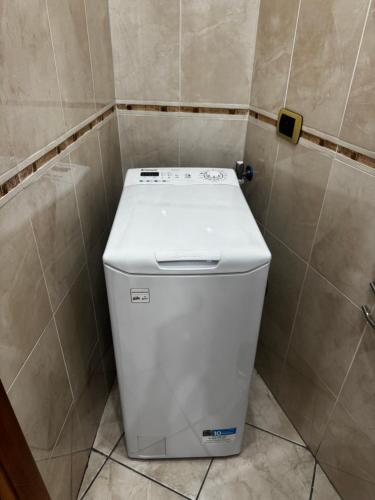a small white toilet in a tiled bathroom at Santa Maria Home in Naples