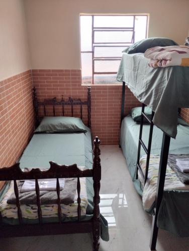 a room with two bunk beds and a window at Hostel da Ladeira in Ouro Preto