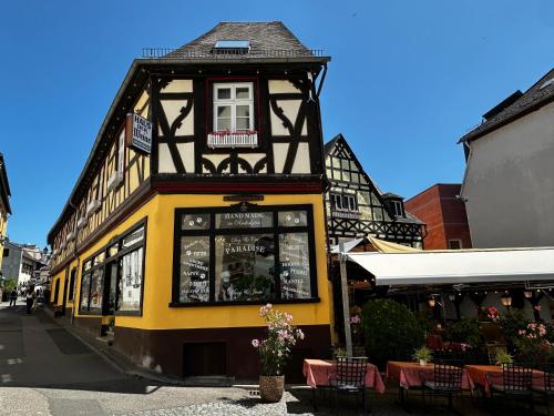 a yellow and black building on a street at Haus der Weine in Rüdesheim am Rhein