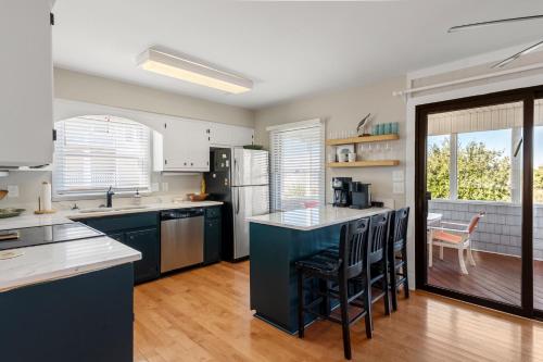 a kitchen with a blue island in the middle at Slumbering Duck in Sanderling