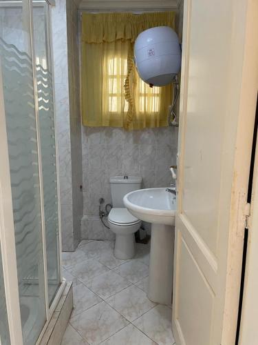 a bathroom with a toilet and a sink and a shower at Aghadir Village قرية اغادير in El Alamein