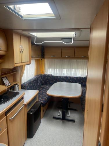 a dining room with a table and a couch at Maszoperia Sun4hel Kite & Wind & Surf in Jastarnia