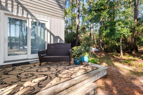 a chair sitting on the front porch of a house at Sound Choice In Manteo in Manteo