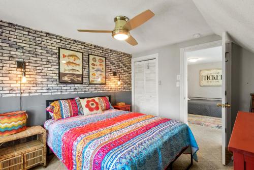 a bedroom with a bed and a brick wall at Sound Choice In Manteo in Manteo