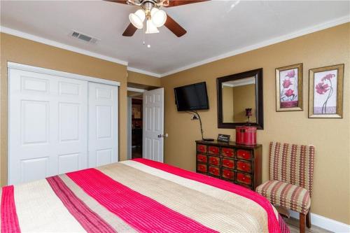 a bedroom with a bed and a ceiling fan at Jacks Spot MIBC 116 in Mustang Beach