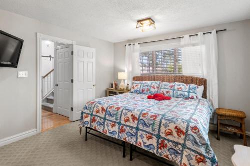 a bedroom with a bed with a red teddy bear on it at Sound Choice In Manteo in Manteo