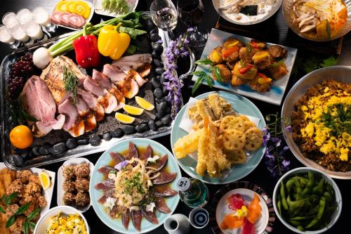 a table topped with lots of different types of food at Hotel Koryu in Fujikawaguchiko