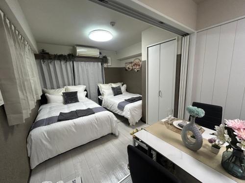 Postel nebo postele na pokoji v ubytování メルシアターリゾート3