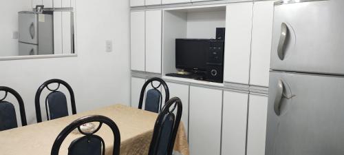 a kitchen with a table and a refrigerator at Alquilo Casa en Barrio Bombal in Barraquero