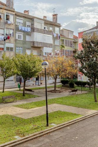 a street light in a park in front of a building at Amadora Flat 4 in Amadora