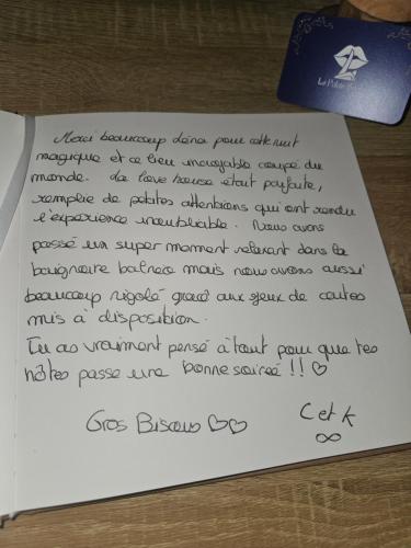 a handwritten letter sitting on top of a table at Le Palais Secret 66 Loveroom in Saint-Féliu-dʼAvall