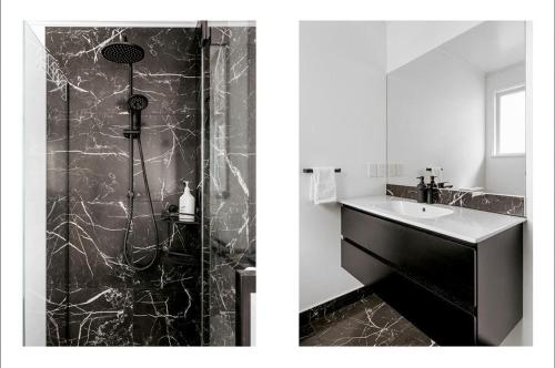 a black and white bathroom with a shower and a sink at Your Downtown Mount Maunganui Escape Awaits! in Mount Maunganui