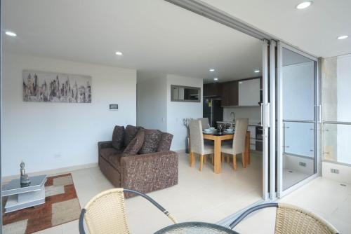 a living room with a couch and a table at Luxury air conditioning near laureles in Medellín