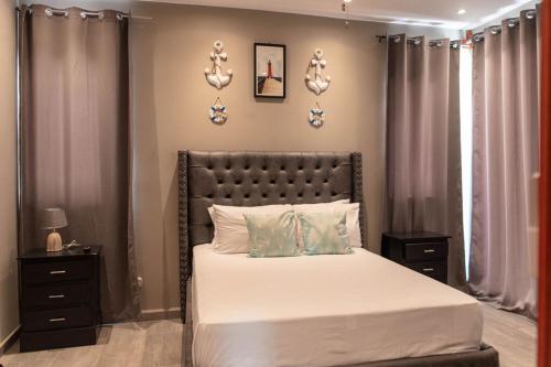 a bedroom with a large bed with white sheets at 3BR villa, 4 bathrooms, private pool & a Free-Ford EcoSport 2018 in Dixon Cove