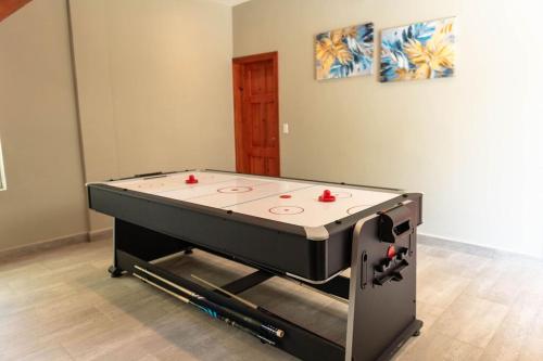 a ping pong table in a room with a table at 3BR villa, 4 bathrooms, private pool & a Free-Ford EcoSport 2018 in Dixon Cove
