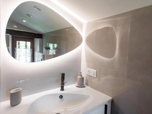 a bathroom with a sink and a mirror at Bastide St John in Séguret
