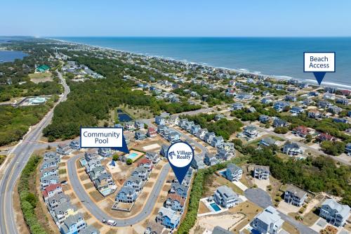 an aerial view of a subdivision with houses and the ocean at Stella Blue in Corolla