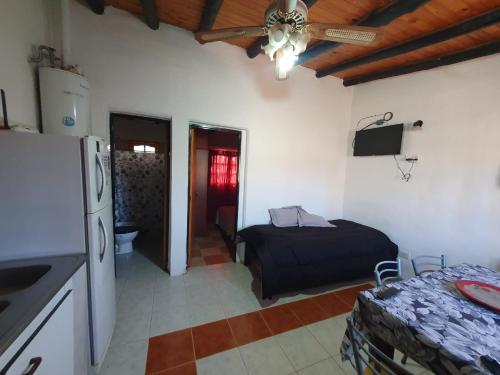 a kitchen with a bed and a refrigerator in a room at MARY ORM House 2 in Malargüe