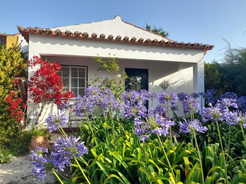 a house with purple flowers in front of it at Casas do Alpendre in Óbidos