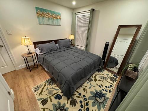 a bedroom with a large bed and a rug at Modern & Stylish 1-BR Condo near Downtown in Boston